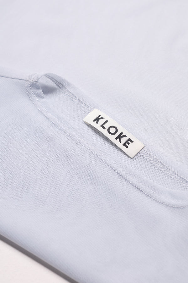 Close-up of the Exist Top’s Japanese power-mesh texture and fine detailing in Pale Blue