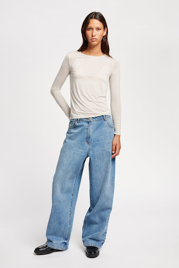 Front view of model in Off white Expansion long-sleeve fitted top in recycled poly with slim silhouette and classic crew neckline