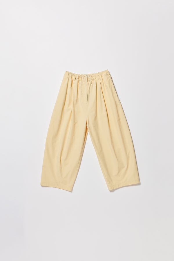 Flat front the Factor Pleat Pant Buttermilk yellow. A relaxed silhouette defined by an encased elastic waistband. 