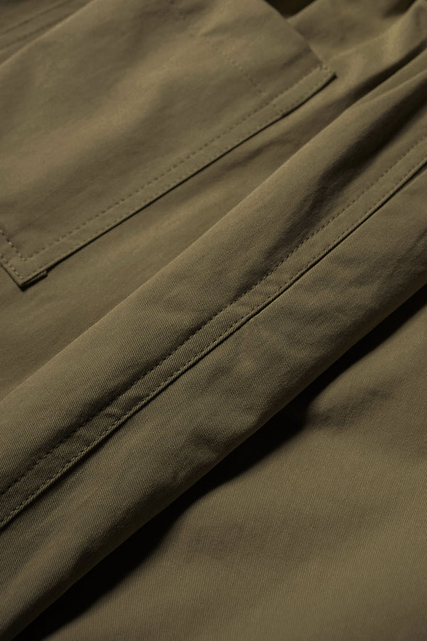 Close up fabric shot of the Factor Pleat Pant Olive Green. A relaxed silhouette defined by an encased elastic waistband. 