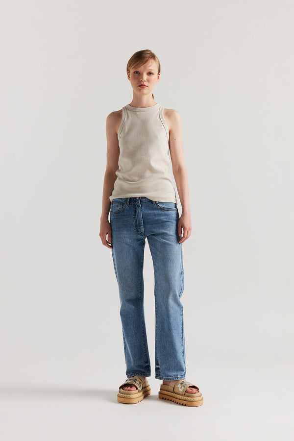 Front of Model wearing slim-fit Japanese ribbed cotton racer-back tank in Bone Off White