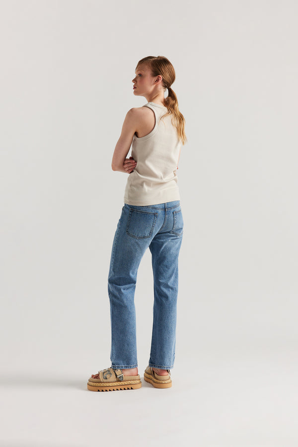 Back of Model wearing slim-fit Japanese ribbed cotton racer-back tank in Bone Off White