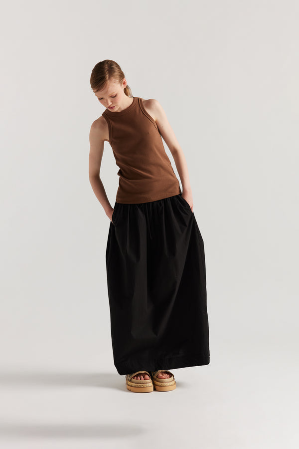 Front of Model wearing slim-fit Japanese ribbed cotton racer-back tank in Cocoa Brown