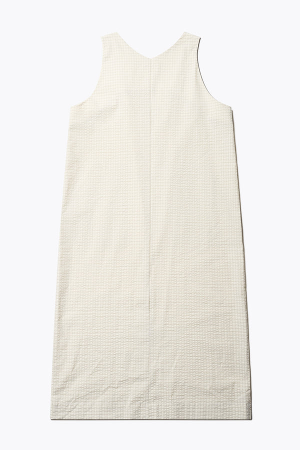 Back of the Long-length Forces Pinafore Dress in Ecru Beige Kloke designed soft seersucker premium cotton . Relaxed fit with a deep rounded neckline, front patch pockets, and a front split for ease of movement. Available in 5 sizes. 