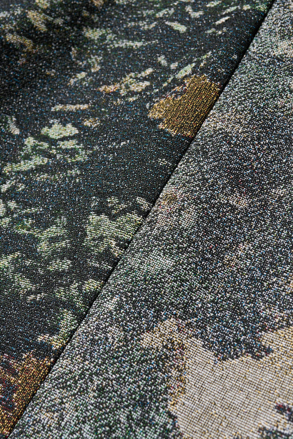 Close up fabric shot of the forge top in green print featuring a unique woven jacquard fabric with real tree camouflage pattern, sculptured panelled sleeves, and a contemporary fit
