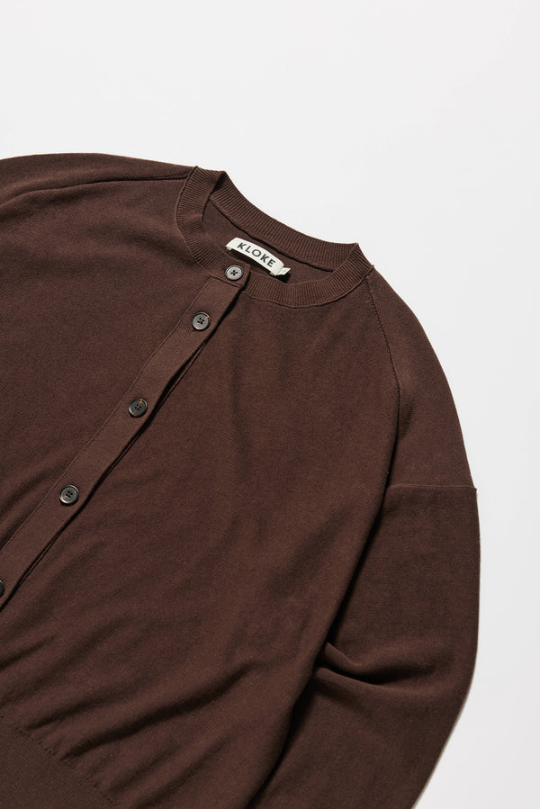 Detail shot of raw-edge seam on soft cotton sweater in brown