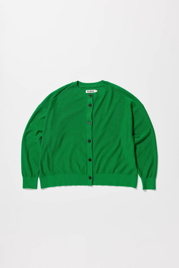Flat front of the green cotton ribbed sweater with button closure and dropped shoulders.