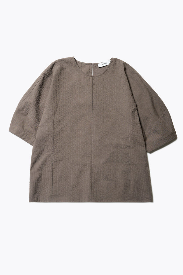 The Geos Panel Top in Brown textured cotton seersucker with gently shaped sculpted sleeves, perfect for summer. Available in 5 sizes. 