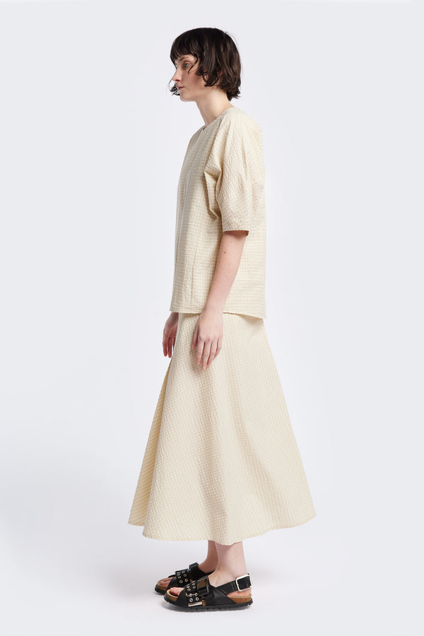 Side of the Geos Panel Top in Ecru beige, textured cotton seersucker with gently shaped sculpted sleeves, perfect for summer. Available in 5 sizes. 