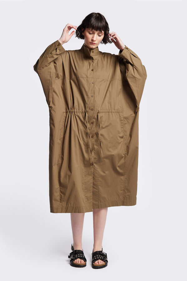 Front of the Olive Brown Iberia Dress, an oversized day dress with loose sleeves and underarm gusset detail, featuring adjustable ties at the front and back for a cinched waist or relaxed fit.