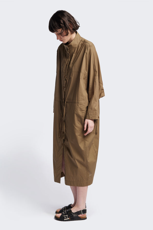 Front of the Olive Brown Iberia Dress, an oversized day dress with loose sleeves and underarm gusset detail, featuring adjustable ties at the front and back for a cinched waist or relaxed fit.