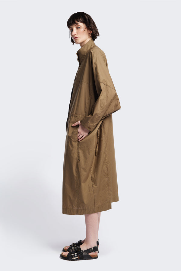 Side of the Olive Brown Iberia Dress, an oversized day dress with loose sleeves and underarm gusset detail, featuring adjustable ties at the front and back for a cinched waist or relaxed fit.