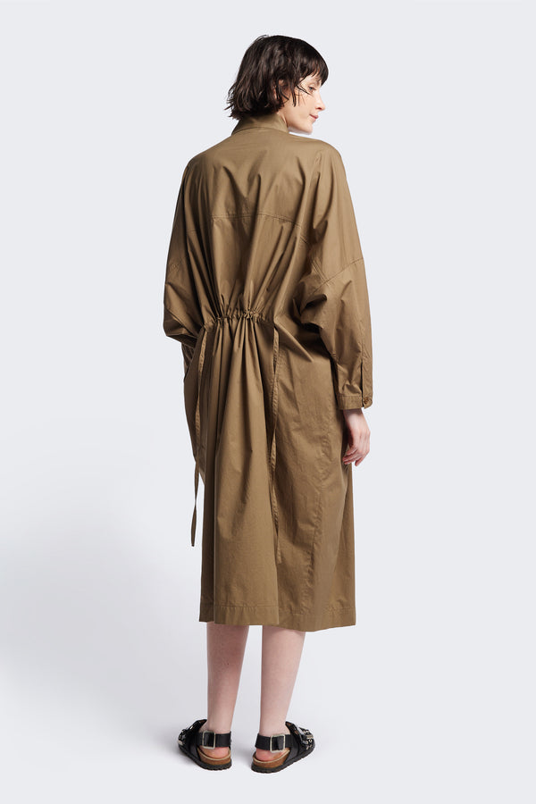 Back of the Olive Brown Iberia Dress, an oversized day dress with loose sleeves and underarm gusset detail, featuring adjustable ties at the front and back for a cinched waist or relaxed fit.