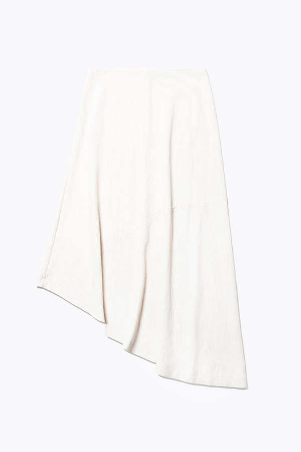 Flat Front of The in time skirt in Ecru, an Asymmetrical skirt with panelled detailing, subtle layered effect, and raw hemline, designed to elongate the figure with a flattering waist fit.