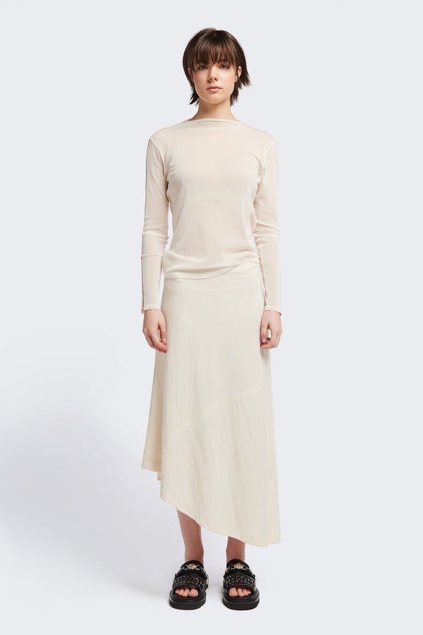 Front of The in time skirt in Ecru, an Asymmetrical skirt with panelled detailing, subtle layered effect, and raw hemline, designed to elongate the figure with a flattering waist fit.