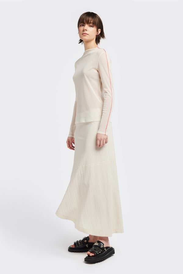 Front of The in time skirt in Ecru, an Asymmetrical skirt with panelled detailing, subtle layered effect, and raw hemline, designed to elongate the figure with a flattering waist fit.