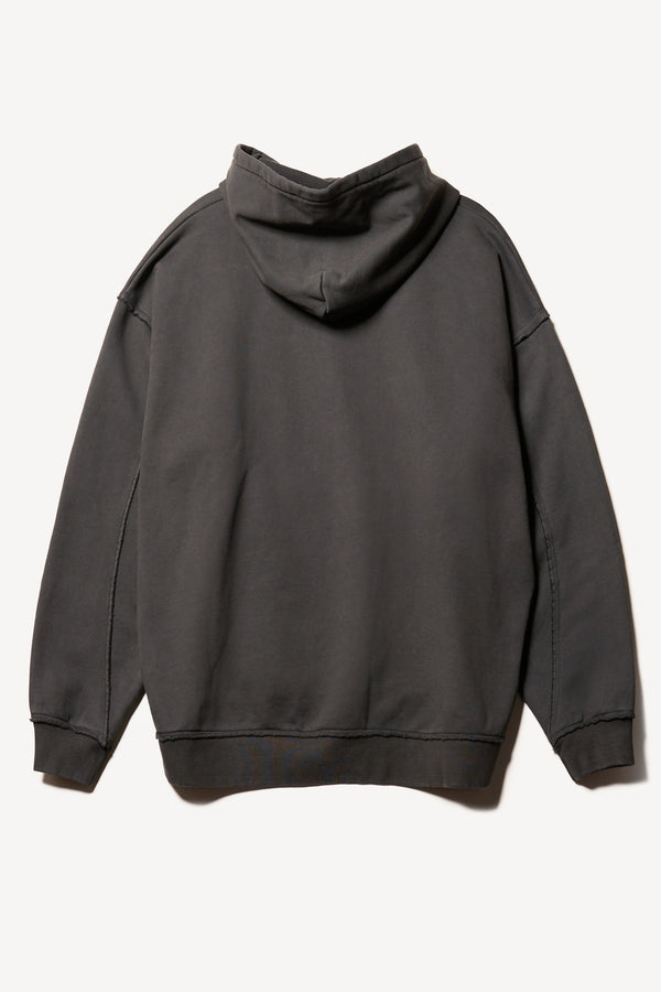 Flat back of relaxed-fit fleece hoodie in black with raw seams and blind-stitched finishing, inspired by classic sportswear silhouettes.