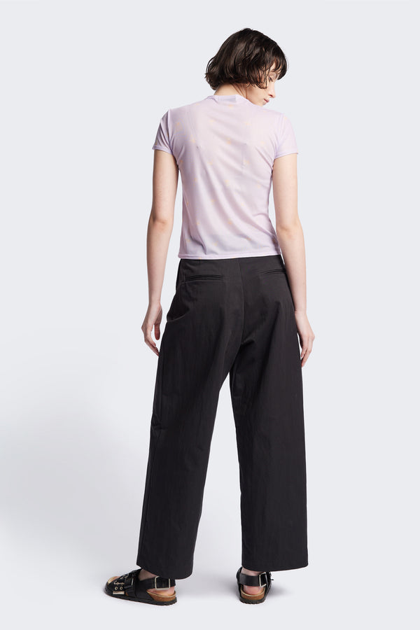 Back of the Interim Pant in Black, Tailored wide-leg in premium cotton with double-front pleats, side slant pockets, jet back pockets, and a hook-and-bar closure. Available in 6 sizes.