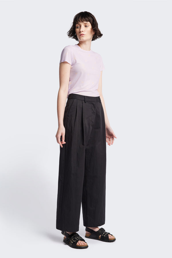 The Interim Pant in Black, Tailored wide-leg in premium cotton with double-front pleats, side slant pockets, jet back pockets, and a hook-and-bar closure. Available in 6 sizes.