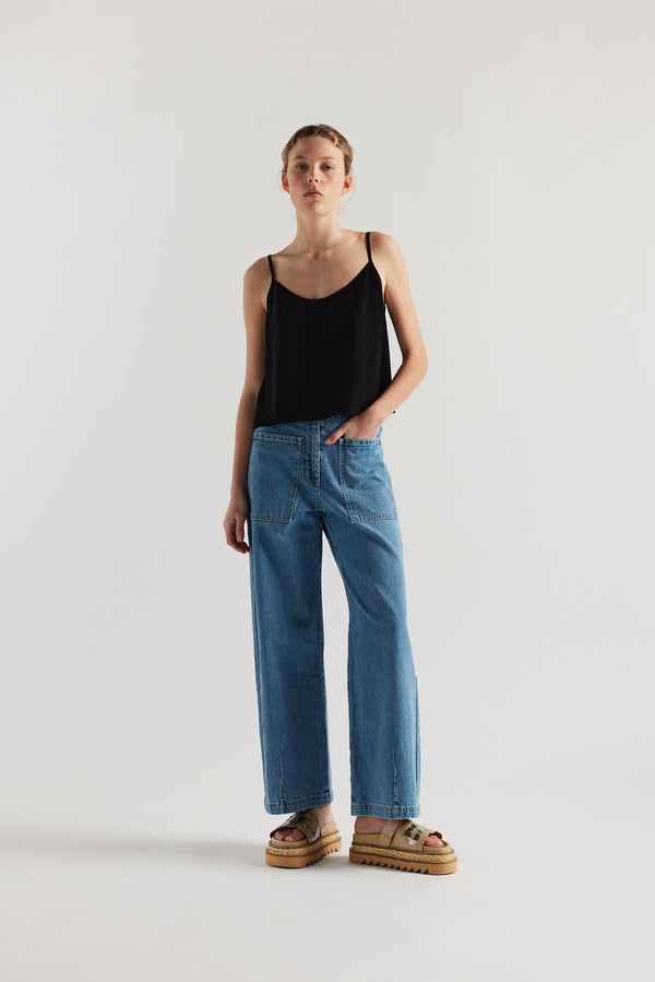 Front of female model in the straight wide-leg denim jeans with a higher-rise waist, patch pockets, and back yoke detail, shown from the front.