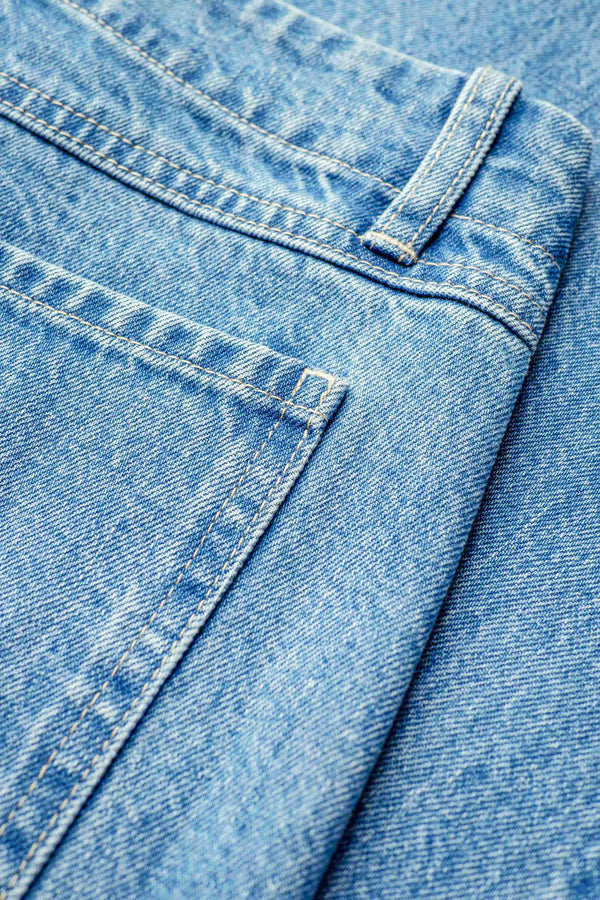 A close up of The Interval Jean in Pale Wash. A well-loved Kloke classic. A straight, wide leg with higher rise waist, back yoke detail, and feature patch pockets. Crafted from premium 12oz Japanese denim.