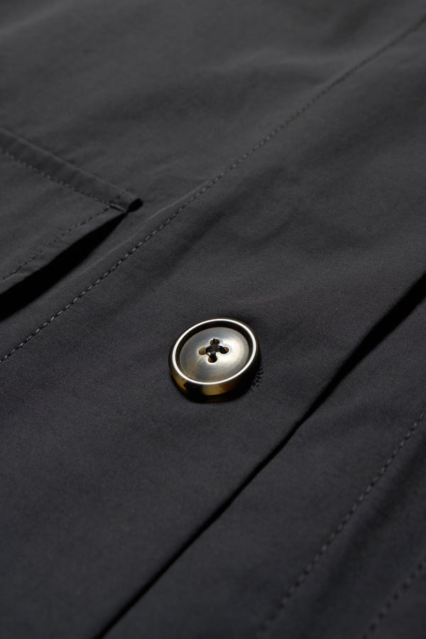 Details of Kestrel Shirt Black – relaxed long sleeve shirt with back button placket and scoop hemline, worn by model. Available in XXS, XS, S, M, L 