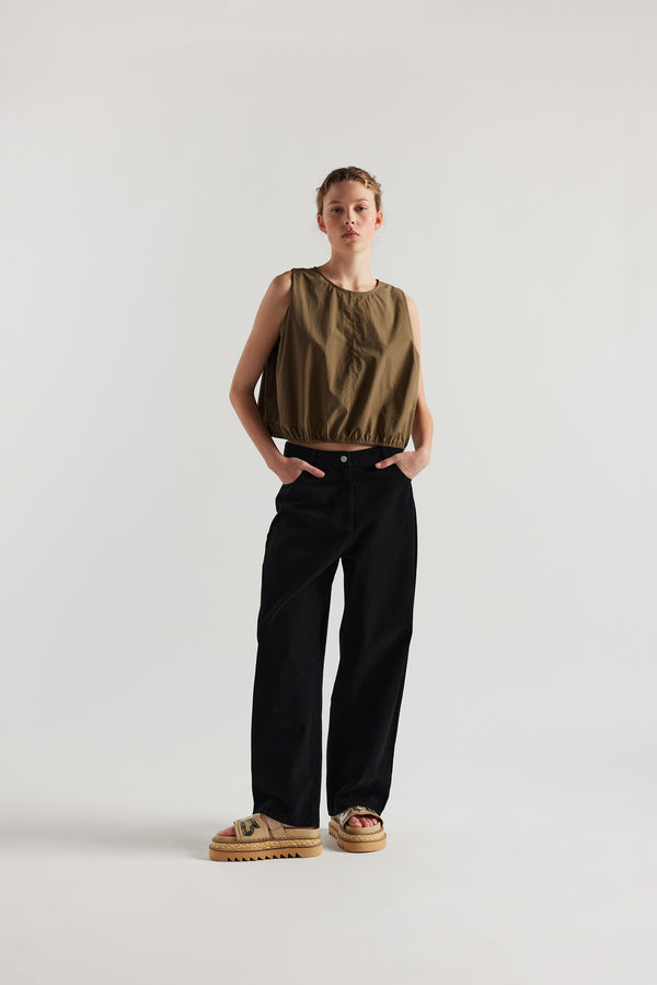 Front view of female model in the Olive Lambent Top front view showing round neckline and centre-front seam detail
