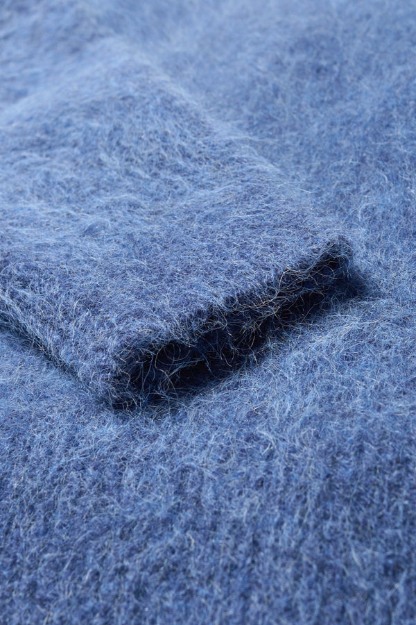Close up soft fuzzy fabric detail of the alpaca blend Laurel Crew Neck Knit Sweater in indigo marle. 