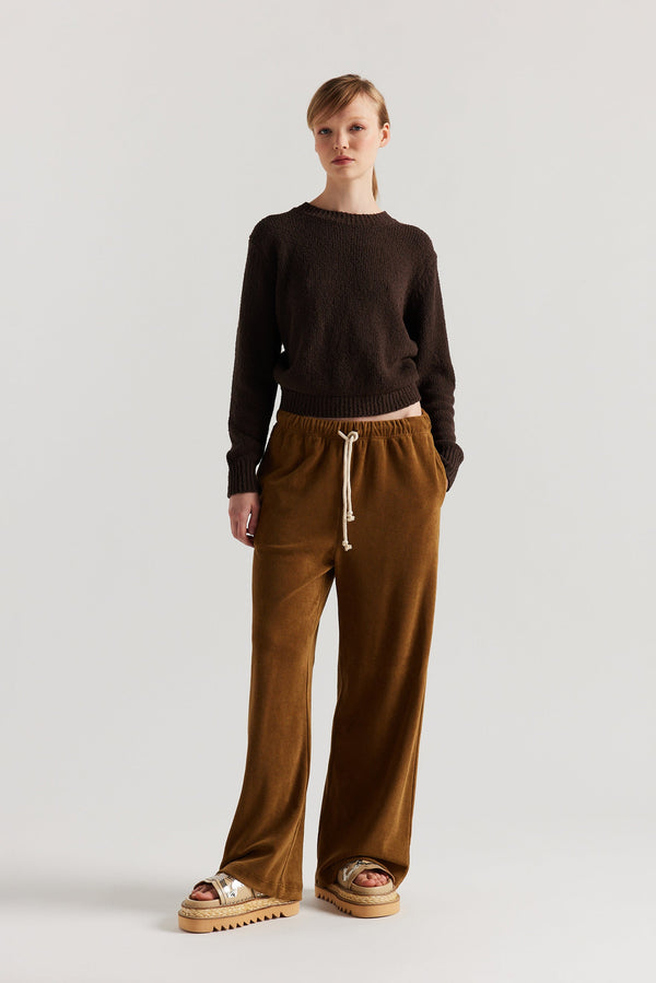 Front of model in the brown Levity Tie Top with open back and adjustable tubular ties in soft cotton–nylon knit