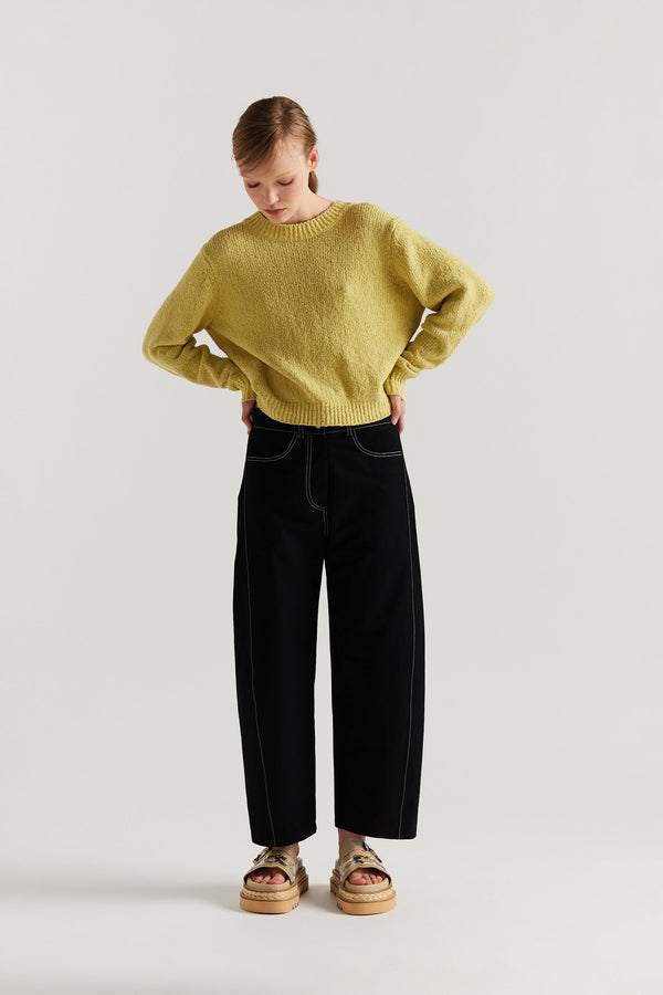 Front of model in the yellow Levity Tie Top with open back and adjustable tubular ties in soft cotton–nylon knit