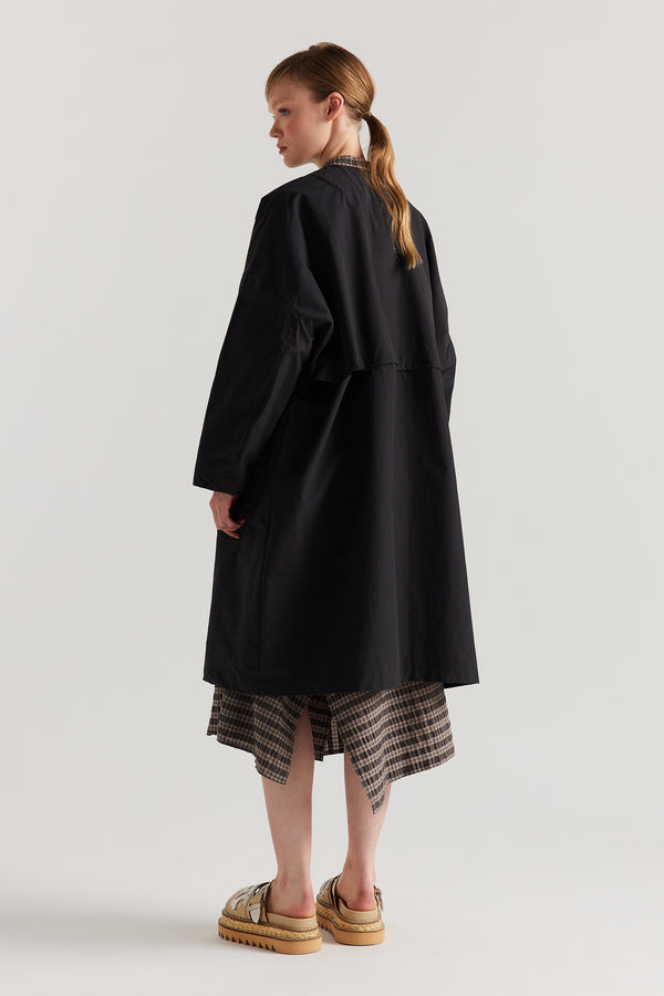 Back view of the Slate Locate Jacket on model highlighting the storm flap and longer silhouette.