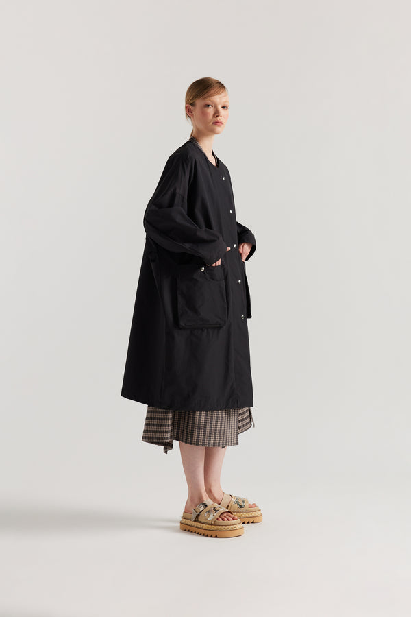 Front side view of the Slate Locate Jacket on model with centre-front button closure and rounded neckline.