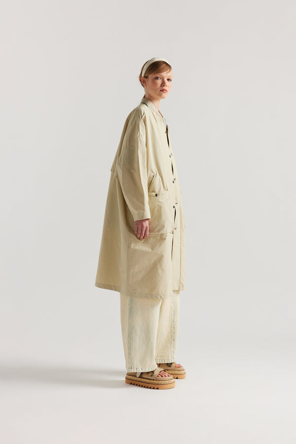 Side view of the Stone Locate Jacket on model with centre-front button closure and rounded neckline.