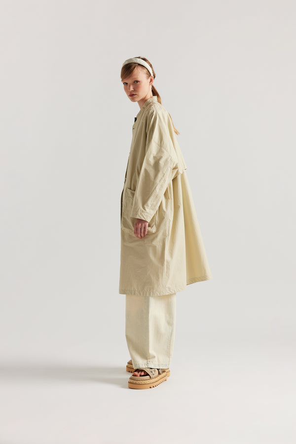 Side view of the Stone Locate Jacket on model with centre-front button closure and rounded neckline.