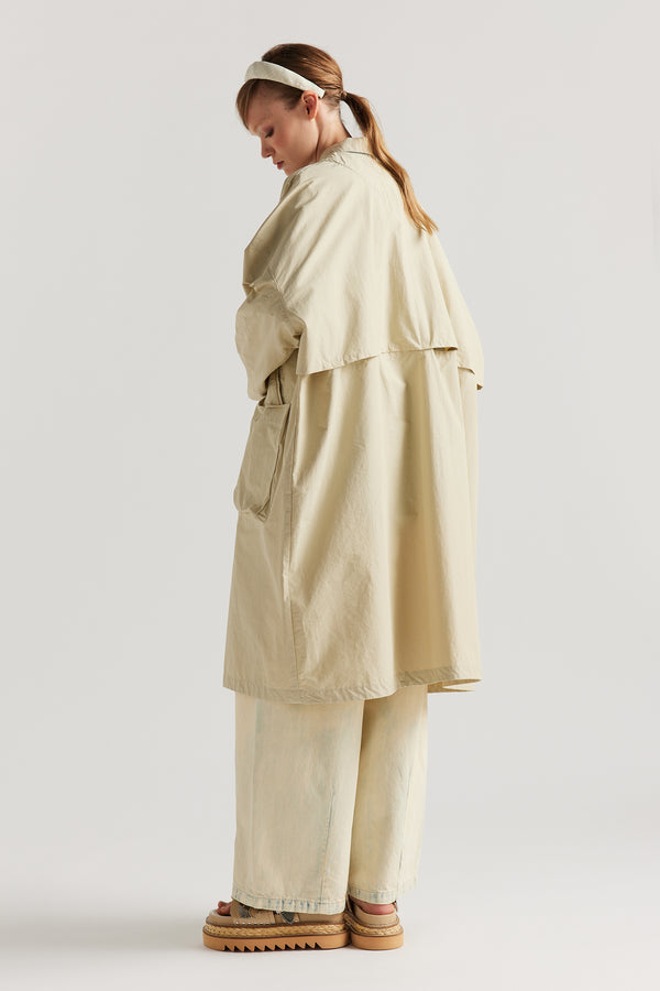 Back view of the Stone Locate Jacket on model highlighting the storm flap and longer silhouette.