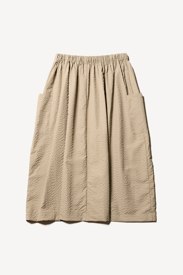Flat Back of the Stone/Beige Minor Skirt, an A-line midi skirt with an elastic waistband and soft gathered detailing, in lightweight Japanese seersucker.