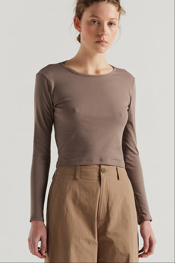 Front of female model in the Mist Ballet Top in fawn brown, long sleeve silhouette.