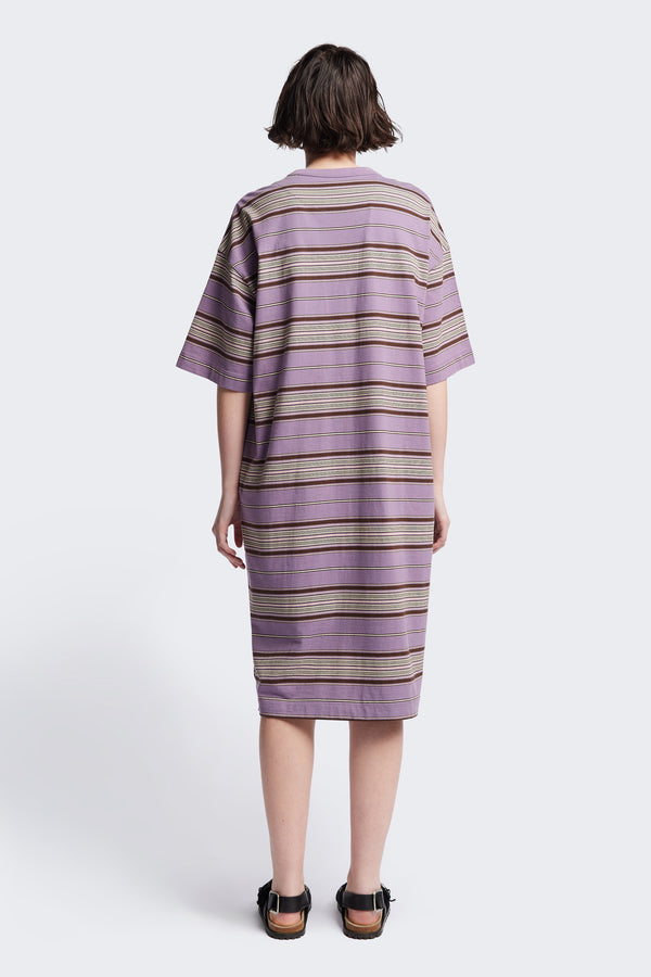 Back of The Nadir Dress in purple stripe, a laid-back style made from pure cotton jersey. This knee-length dress features side-splits, dropped shoulder, and elbow-grazing sleeves. Available in 5 sizes