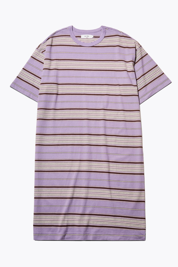 The Nadir Dress in purple stripe, a laid-back style made from pure cotton jersey. This knee-length dress features side-splits, dropped shoulder, and elbow-grazing sleeves. Available in 5 sizes