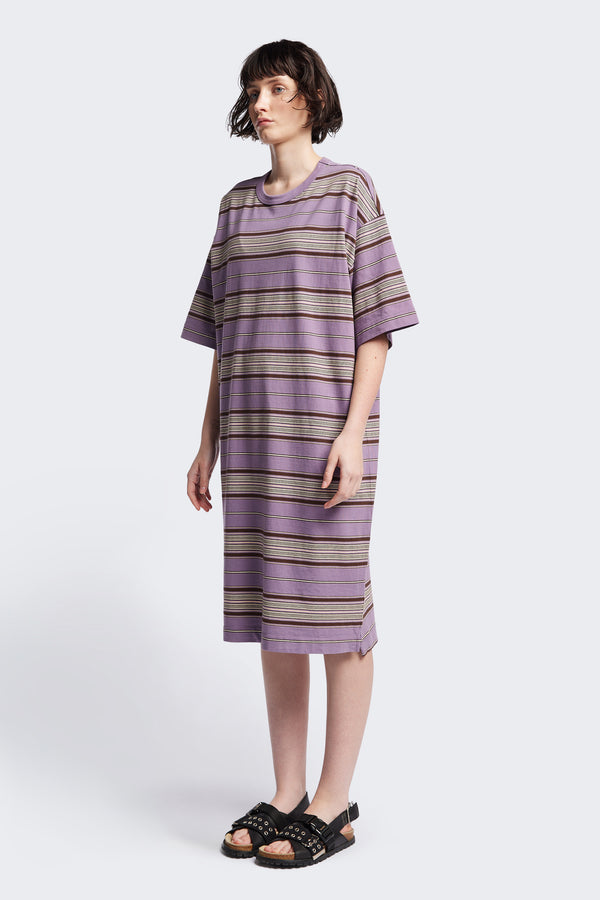 The Nadir Dress in purple stripe, a laid-back style made from pure cotton jersey. This knee-length dress features side-splits, dropped shoulder, and elbow-grazing sleeves. Available in 5 sizes