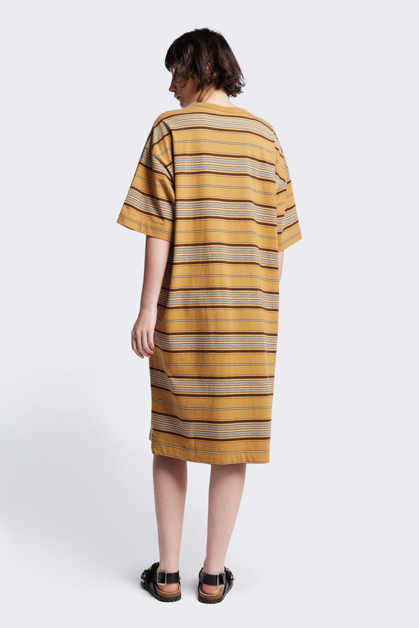 Back of The Nadir Dress in tan stripe, a laid-back style made from pure cotton jersey. This knee-length dress features side-splits, dropped shoulder, and elbow-grazing sleeves. Available in 5 sizes. 