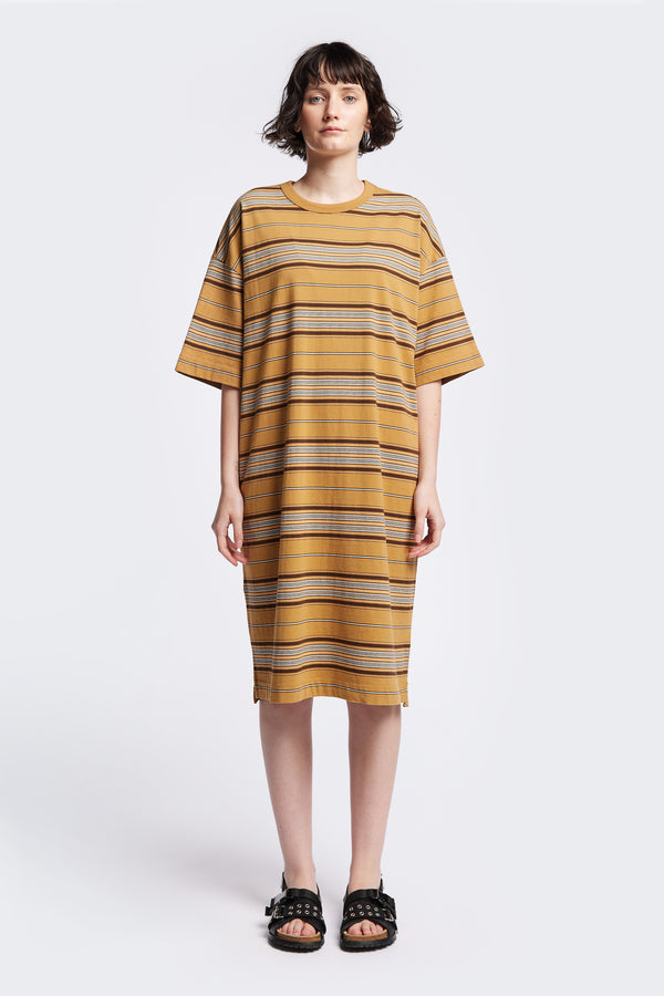 The Nadir Dress in tan, a laid-back style made from pure cotton jersey with blue and white stripes. This knee-length dress features side-splits, dropped shoulder, and elbow-grazing sleeves. Available in 5 sizes. 