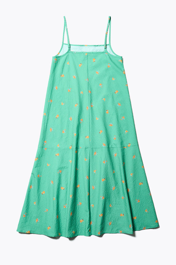 Flat back of The Natant Dress in green floral, a Maxi-length Natant Dress with adjustable thin straps, a straight neckline, and a bias-cut silhouette, made from lightweight printed seersucker. Available in 5 sizes. 