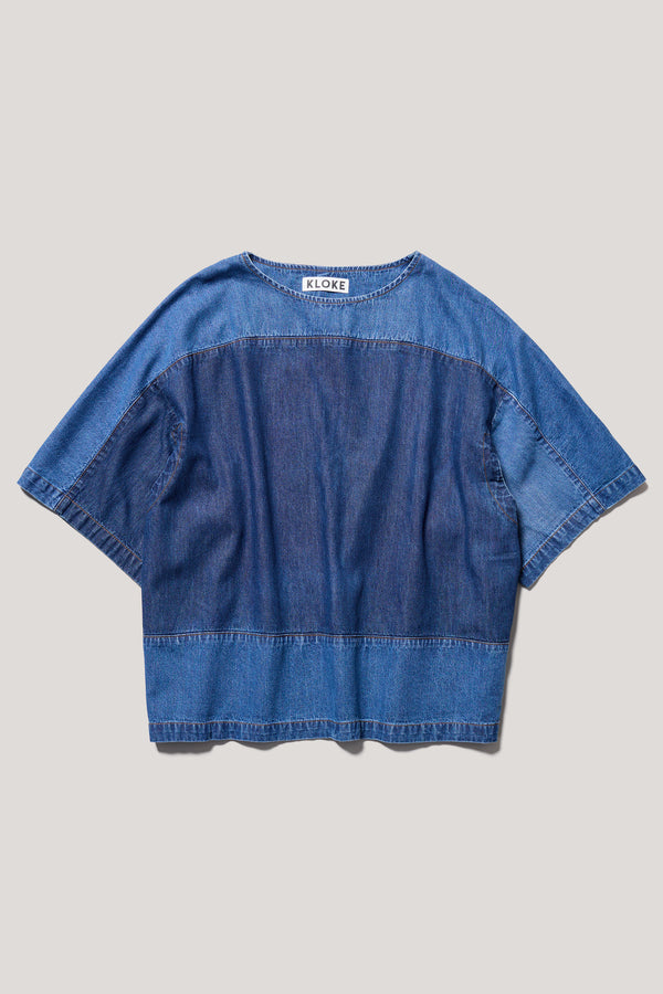 Flat Front of the Norton Top in Dark/Mid blue fade with Ecru tint denim, showing split underarm detail and round neck silhouette.