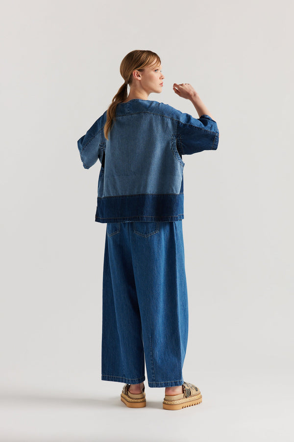 Back view of the Norton Top in Dark/Mid blue fade with Ecru tint denim, showing split underarm detail and engineered panelling  