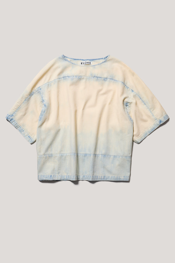 Flat Front of the Norton Top in Mid blue fade with Ecru tint denim, showing split underarm detail and round neck silhouette.