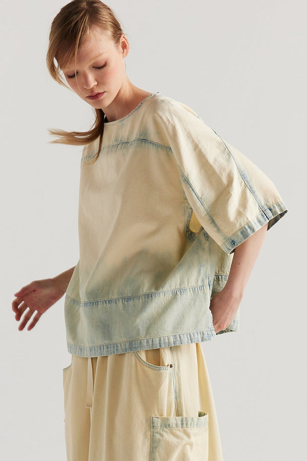 Front view of the Norton Top in Mid blue fade with Ecru tint denim, showing split underarm detail and round neck silhouette.