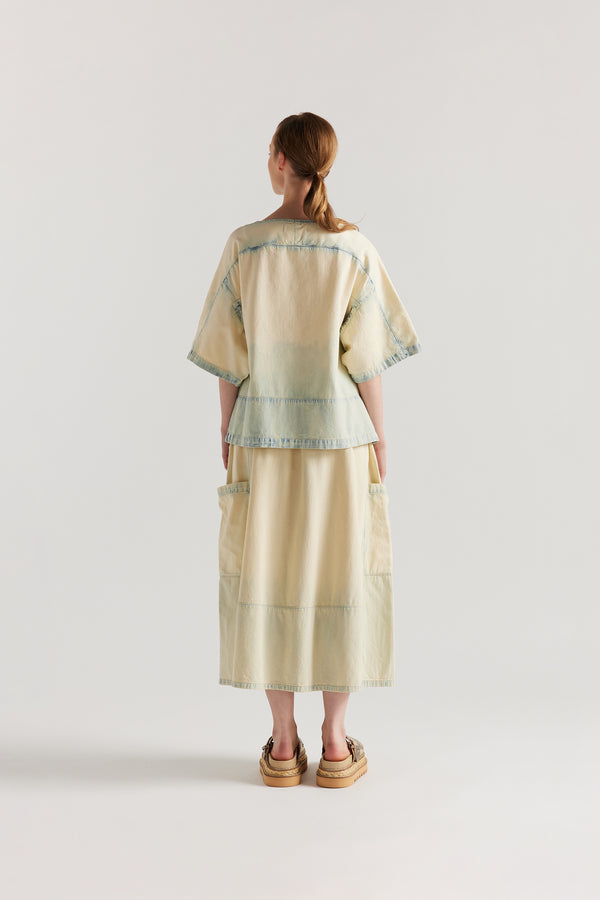 Back view of the Norton Top in Mid blue fade with Ecru tint denim, showing split underarm detail and engineered paneling. 