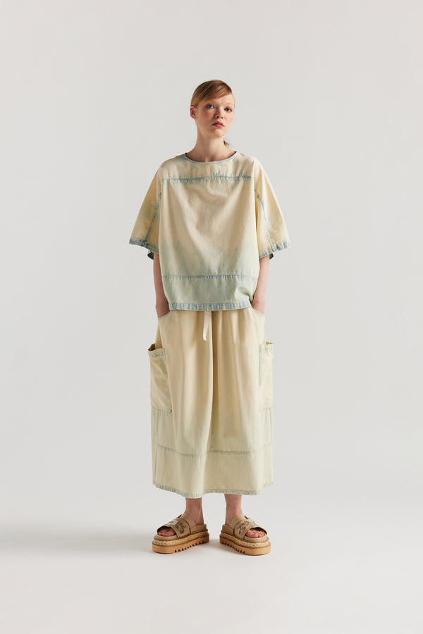 Front view of the Norton Top in Mid blue fade with Ecru tint denim, showing split underarm detail and round neck silhouette.