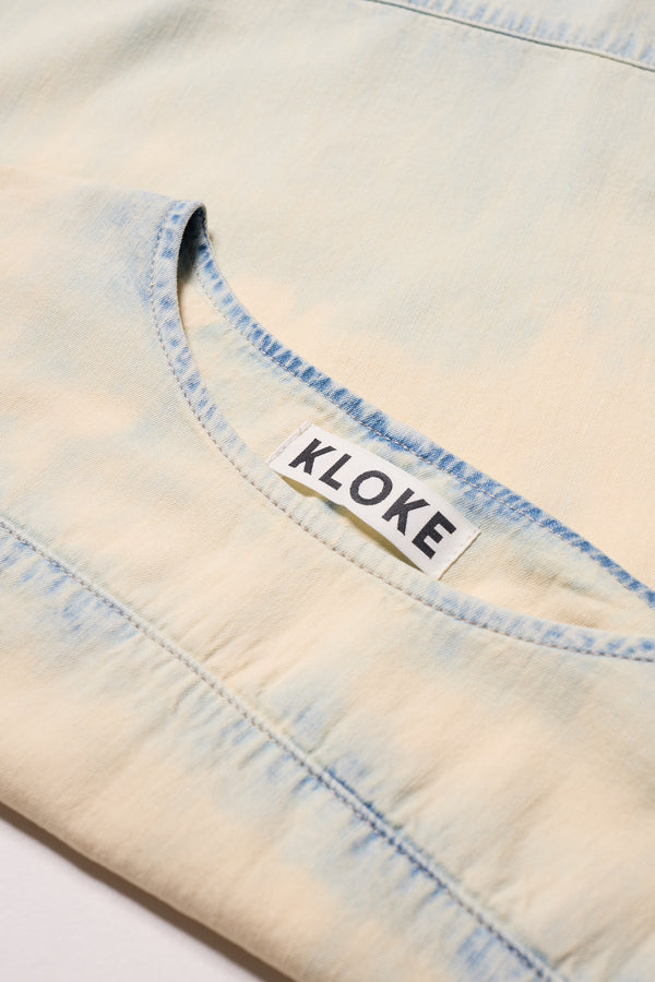 Close-up of the Mid blue fade with Ecru Tint Norton Top  - highlighting the faded denim texture.